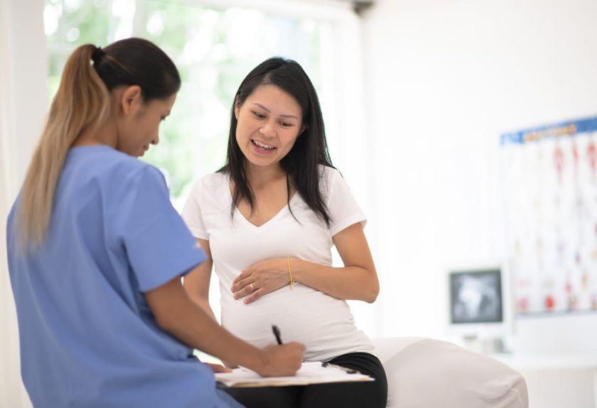 pcmc perinatology center service Hispanic Pregnant Woman Speaks With Her Doctor at a Check-Up stock photo
